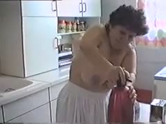 As she cleans the kitchen, my elderly, breasty housekeeper takes off her clothes.